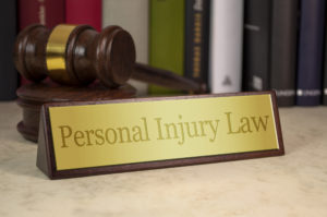 What Is A Personal Injury Lawsuit? Name plate law books and gavel rendering
